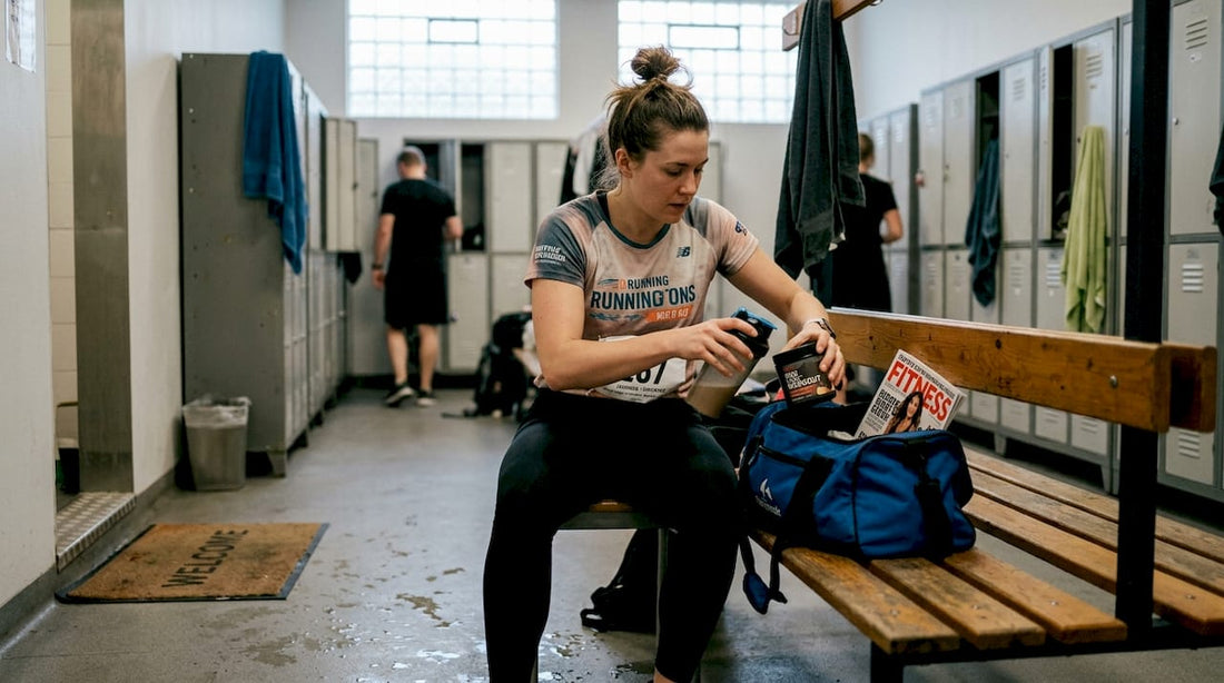 Female athlete packing gym bag locker room