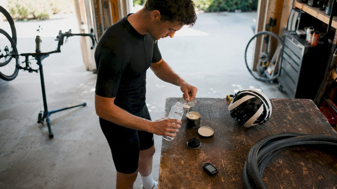 Cyclist preparing hydration formula at kitchen table