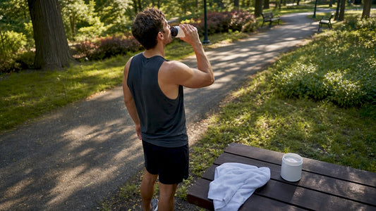 Athlete hydrating after intense sports training outdoors